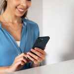 close-up-smiley-woman-holding-smartphone.jpg