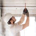 electrician-installer-with-tool-in-his-hands-working-with-cable-on-the-construction-site.jpg