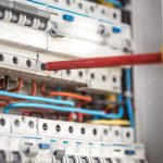 man-an-electrical-technician-working-in-switchboard-with-fuses-installation-and-connection-of-electrical-equipment-close-up.jpg